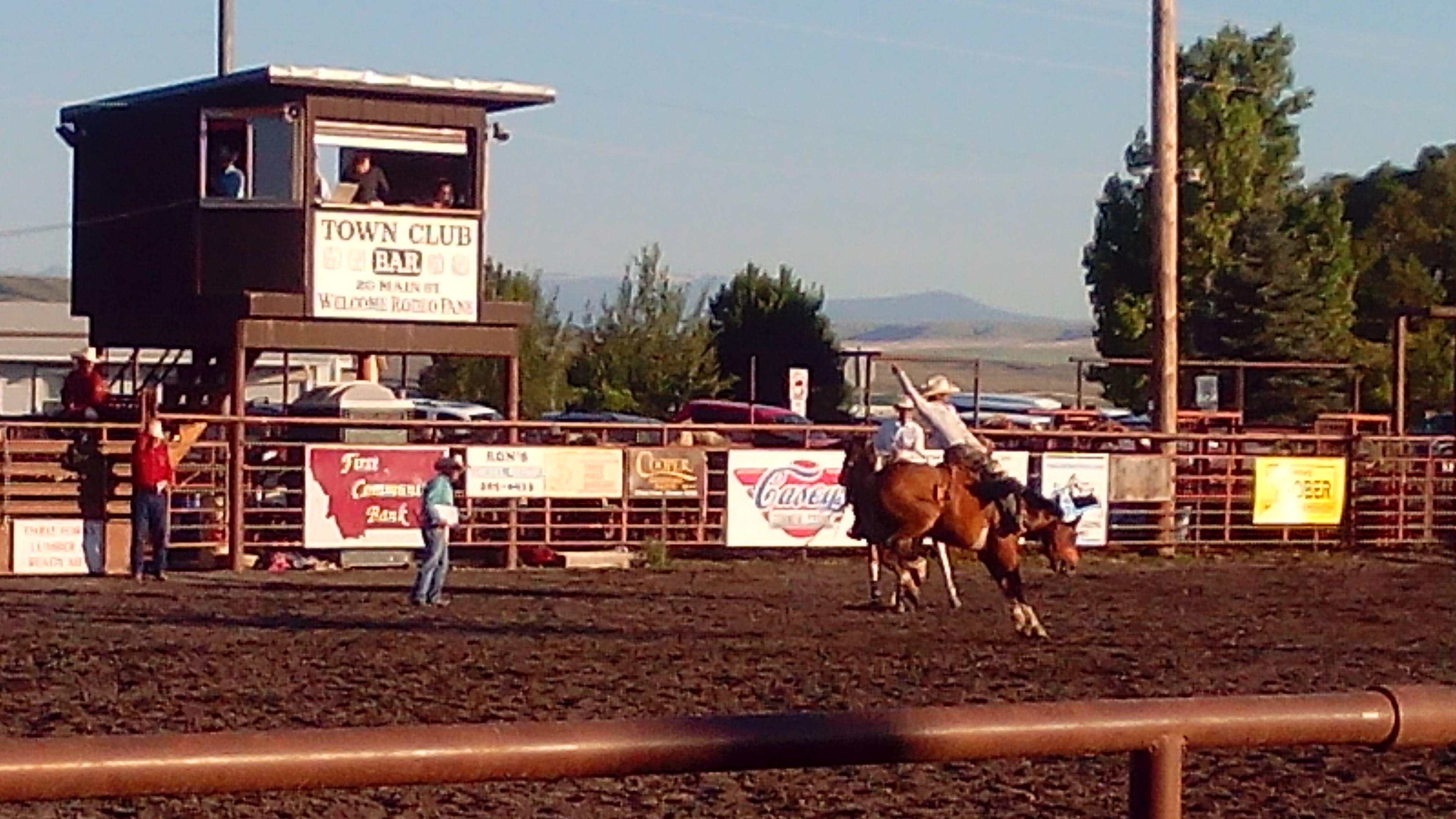 Image of the Three Forks Montana Rodeo with a cowboy riding a Bronc.